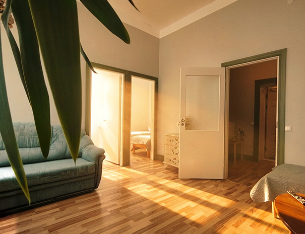 View from the living room of the Family Suite at Hostel Lõuna, showing doors to both separate twin bedrooms and the hallway.