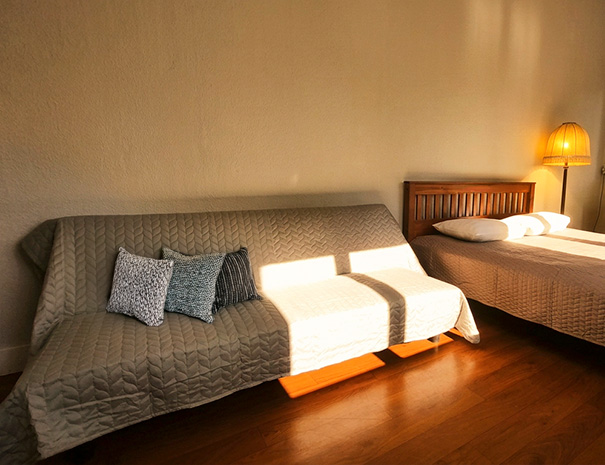 A comfortable sleeper sofa in the Queen Room at Hostel Lõuna, which can be used as a cozy extra bed.